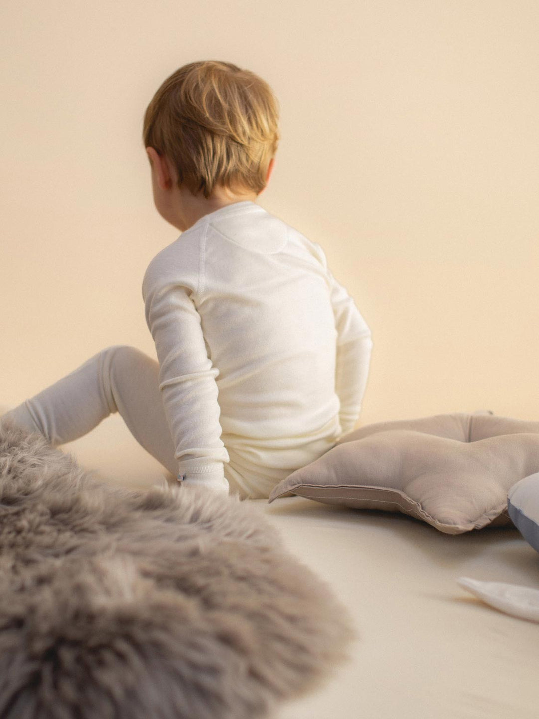 Merino wool kids thermal baselayer pyjama in white back view #colour_pure-ivory