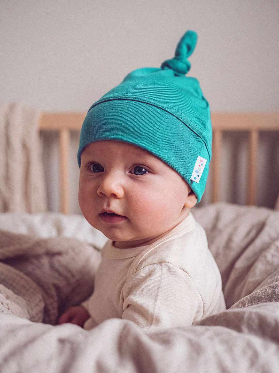 Merino baby hat green close #colour_wild-green