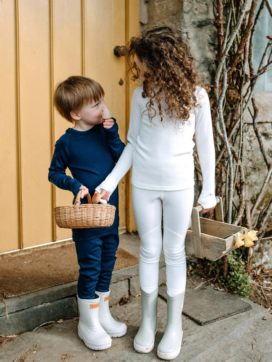 Merino wool kids thermal baselayer pyjama in white navy #colour_pure-ivory