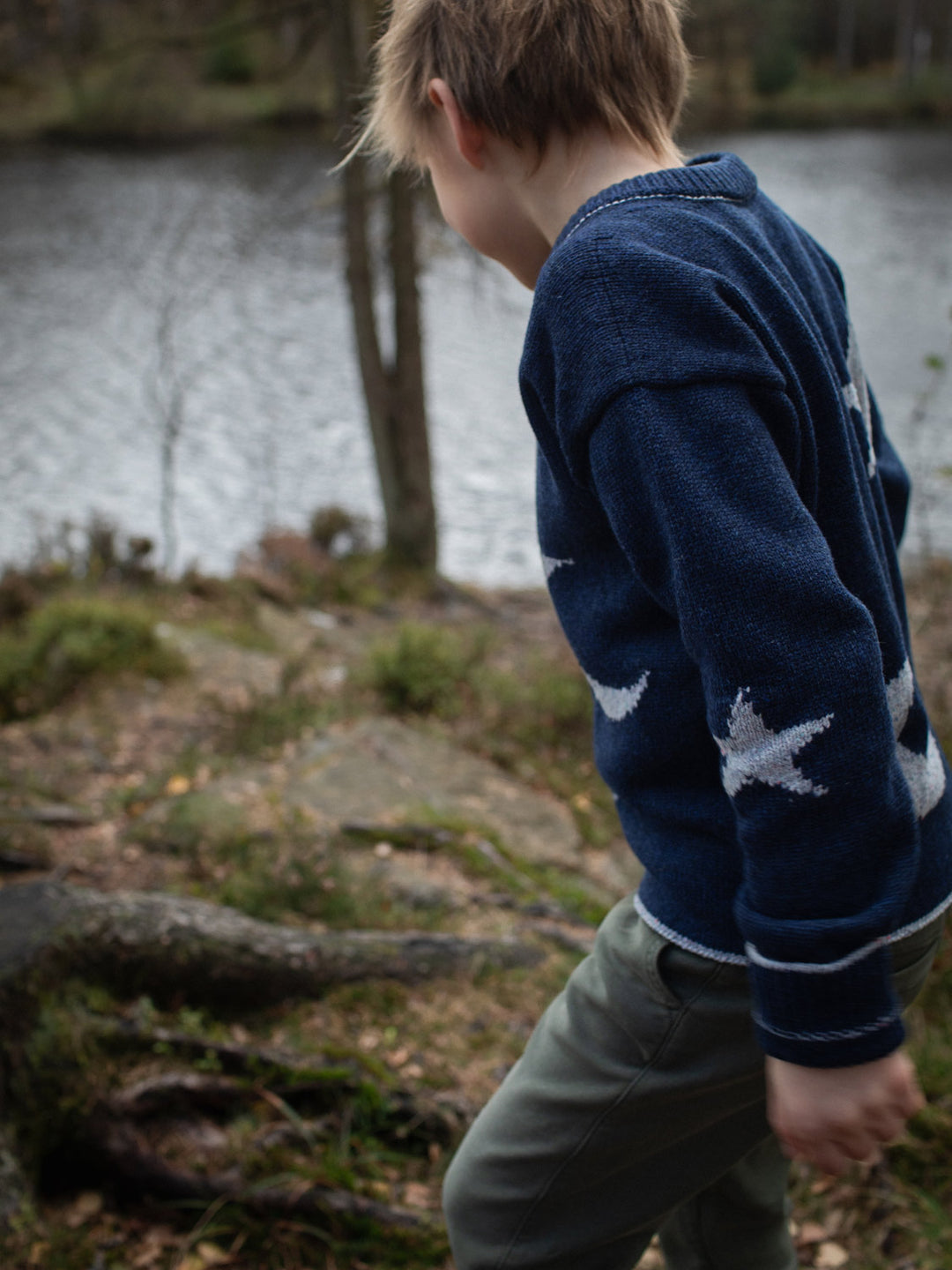 Navy blue merino wool kids knitted sweater gift hand knitted with star and moon design side #colour_nocturne