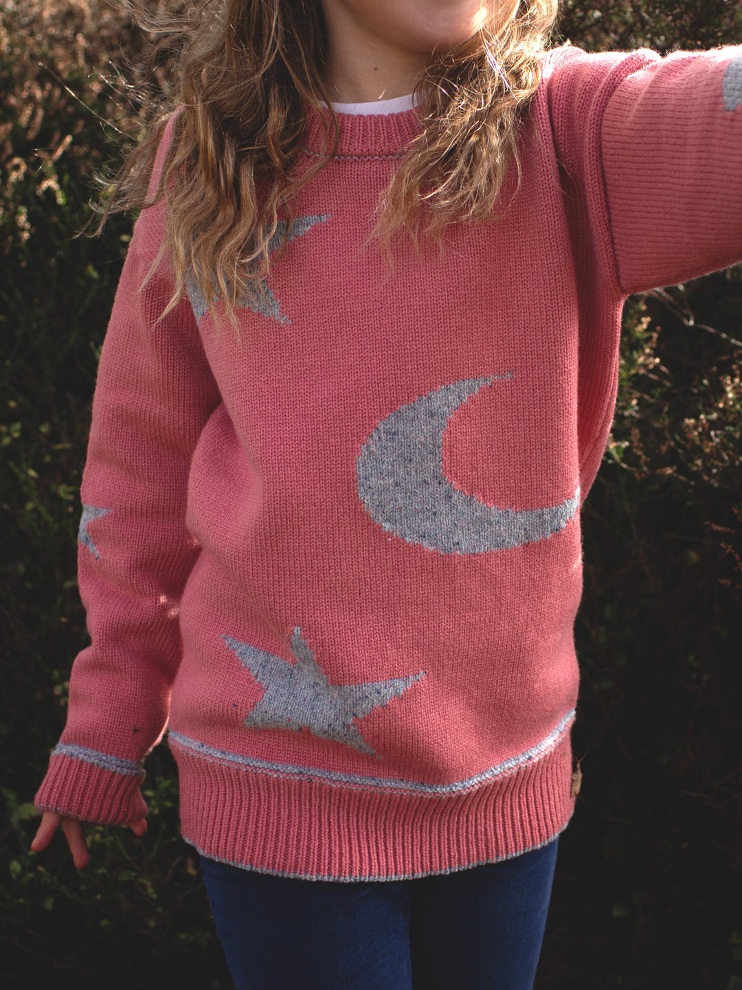 pink girls merino wool baby toddler and kids knitted sweater gift hand knitted with star and moon design close up #colour_aurora