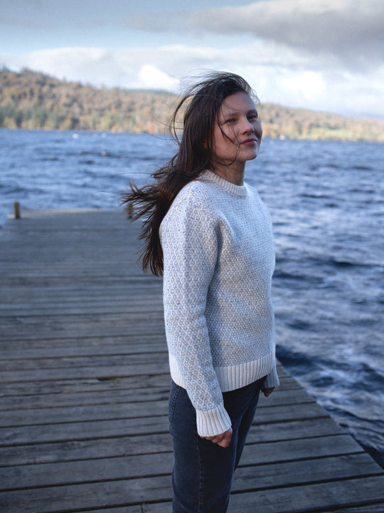 Merino wool womens crew neck jumper sweater knit in neutral grey and white ivory tones side view #colour_glacial-quartz