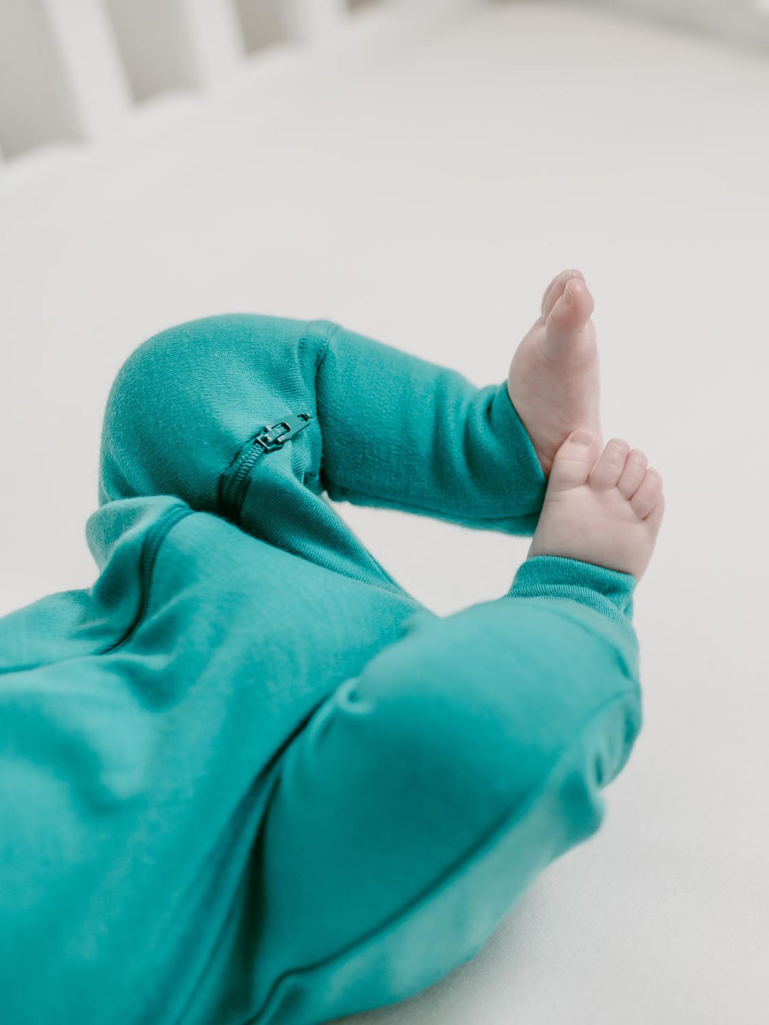 merino baby sleepsuit green detail #colour_wild-green