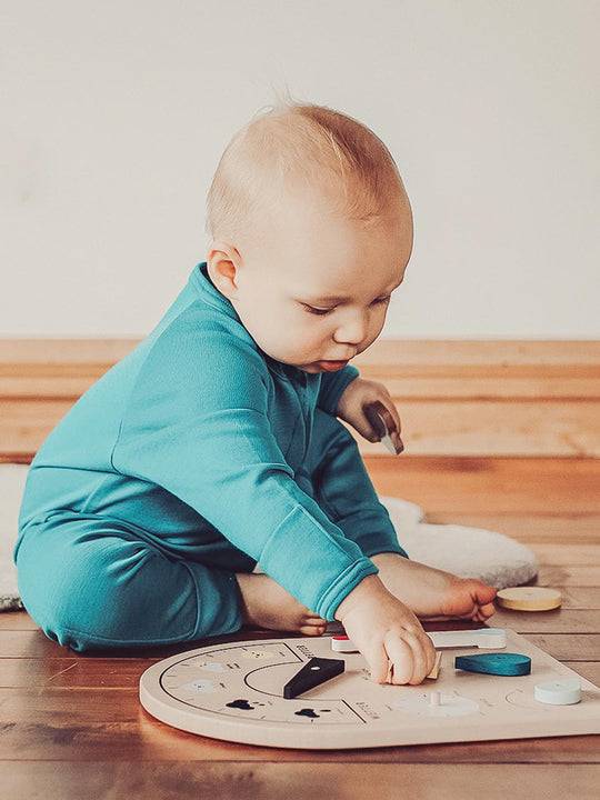 merino baby sleepsuit green zip sitting #colour_wild-green