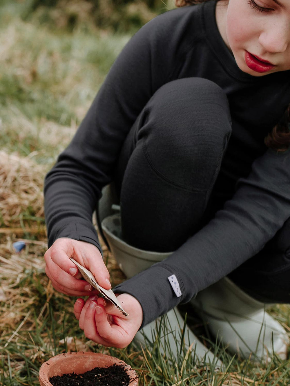 Merino wool kids thermal baselayer pyjama in black closeup #colour_ink