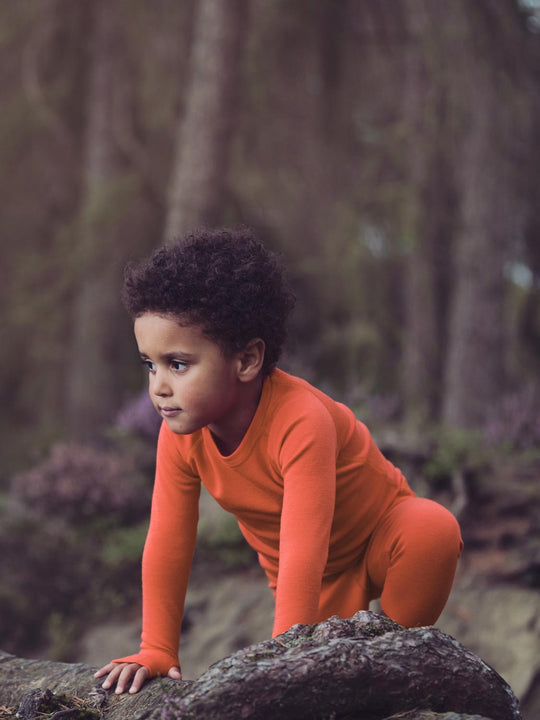 Merino kids thermal baselayer top orange front action  #colour_fox